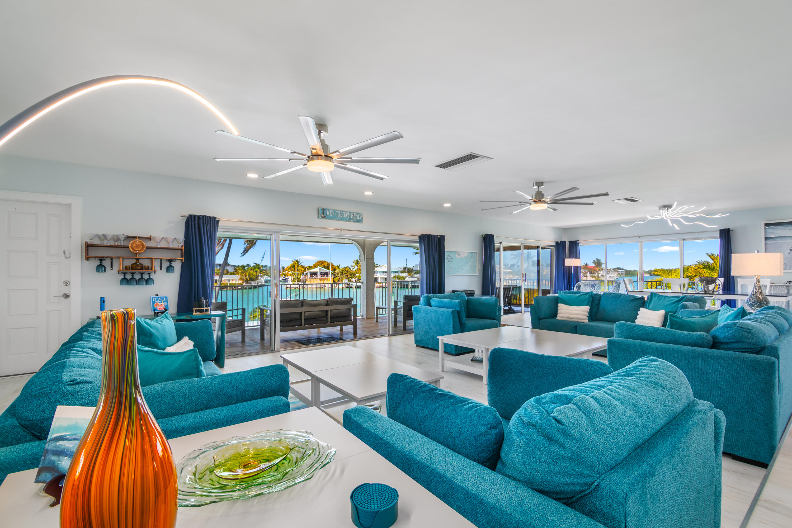 781 9th Street Key Colony Beach, FL 33051 - Photo 10 of 95 a living room with furniture a flat screen tv and a large window