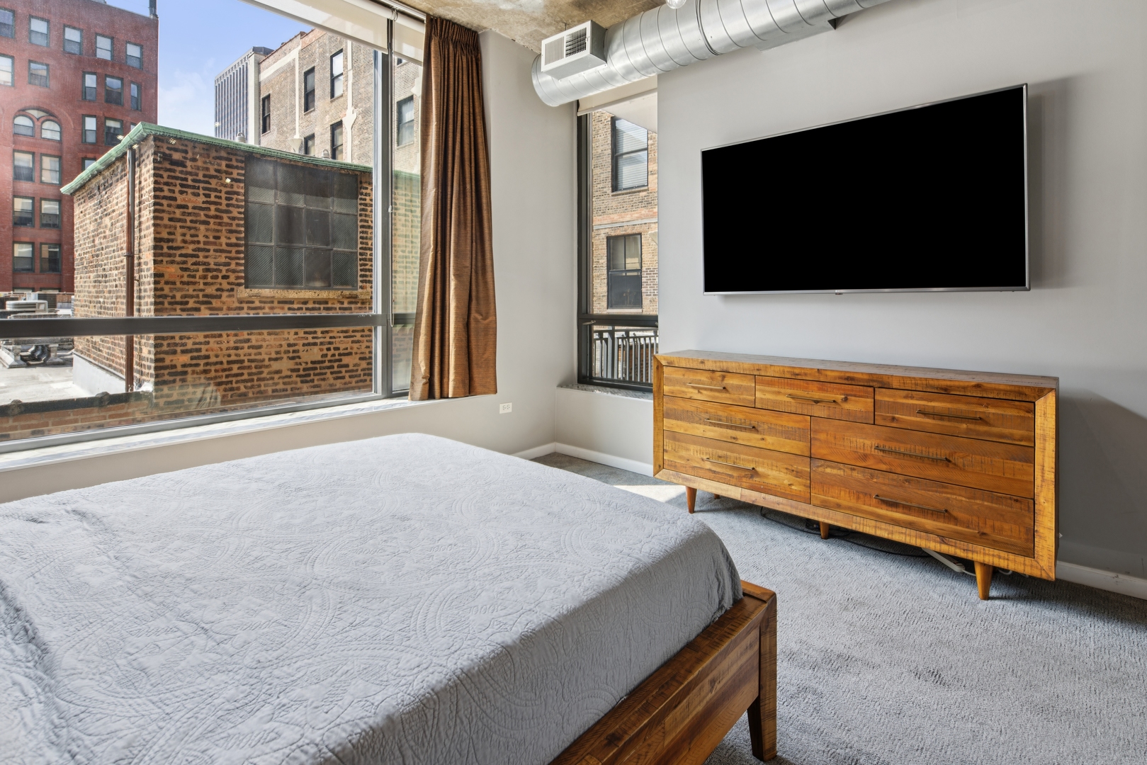 520 South State Street, Unit 816 Chicago, IL 60605 - Photo 10 of 15 a living room with furniture and a flat screen tv