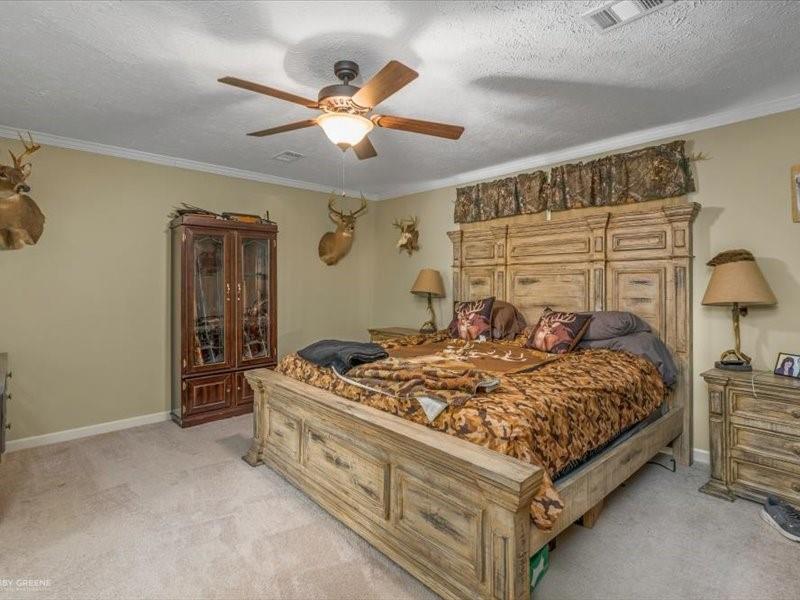 128 Gas Plant Road Doyline, LA 71023 - Photo 9 of 39 a bedroom with a bed and a chandelier