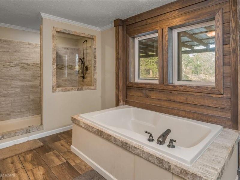 128 Gas Plant Road Doyline, LA 71023 - Photo 12 of 39 a bath tub sitting next to a window