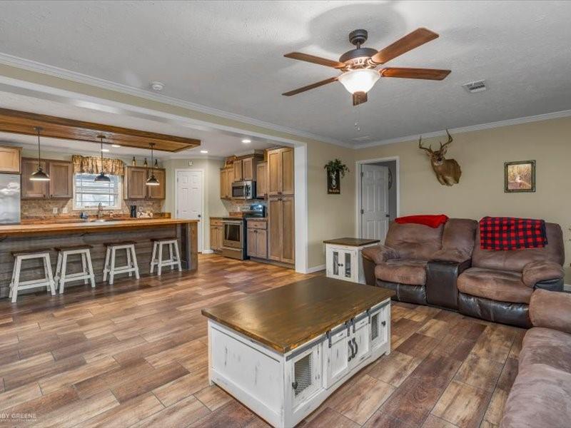 128 Gas Plant Road Doyline, LA 71023 - Photo 4 of 39 a living room with couches and kitchen view with wooden floor
