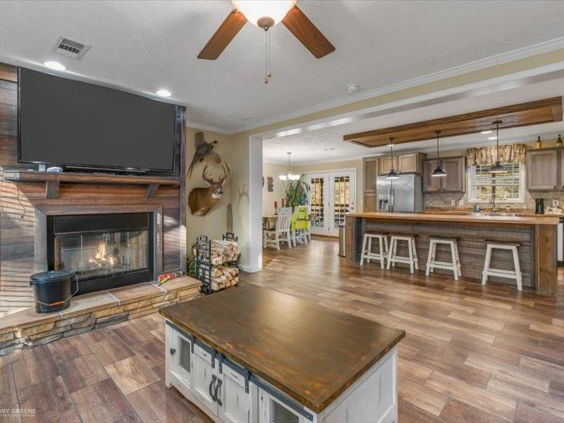 128 Gas Plant Road Doyline, LA 71023 - Photo 5 of 39 a living room with furniture a flat screen tv and a fireplace