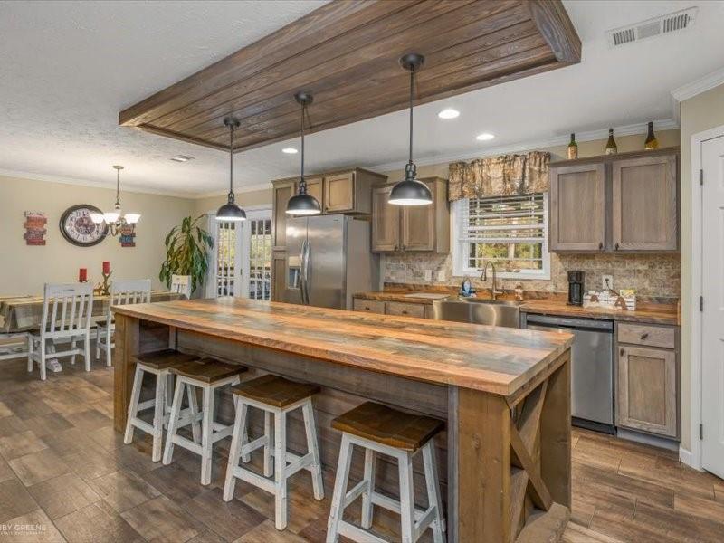 128 Gas Plant Road Doyline, LA 71023 - Photo 6 of 39 a kitchen with stainless steel appliances granite countertop a stove and chairs