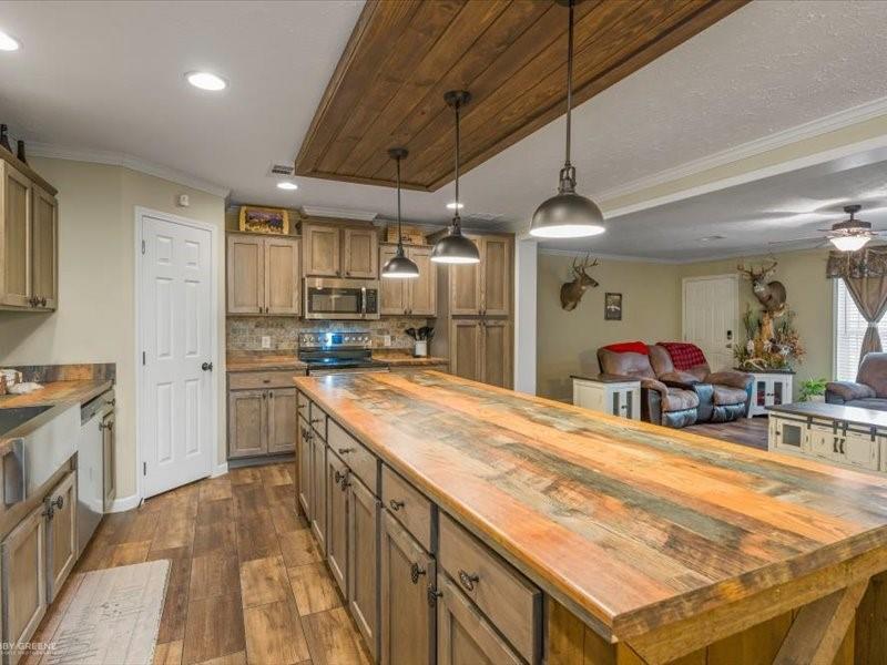 128 Gas Plant Road Doyline, LA 71023 - Photo 39 of 39 a large kitchen with kitchen island a stove a sink dishwasher and a refrigerator with wooden floor