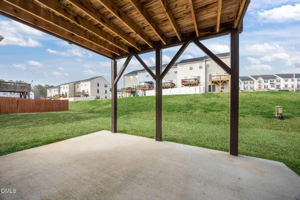 a view of a house with backyard and a tree