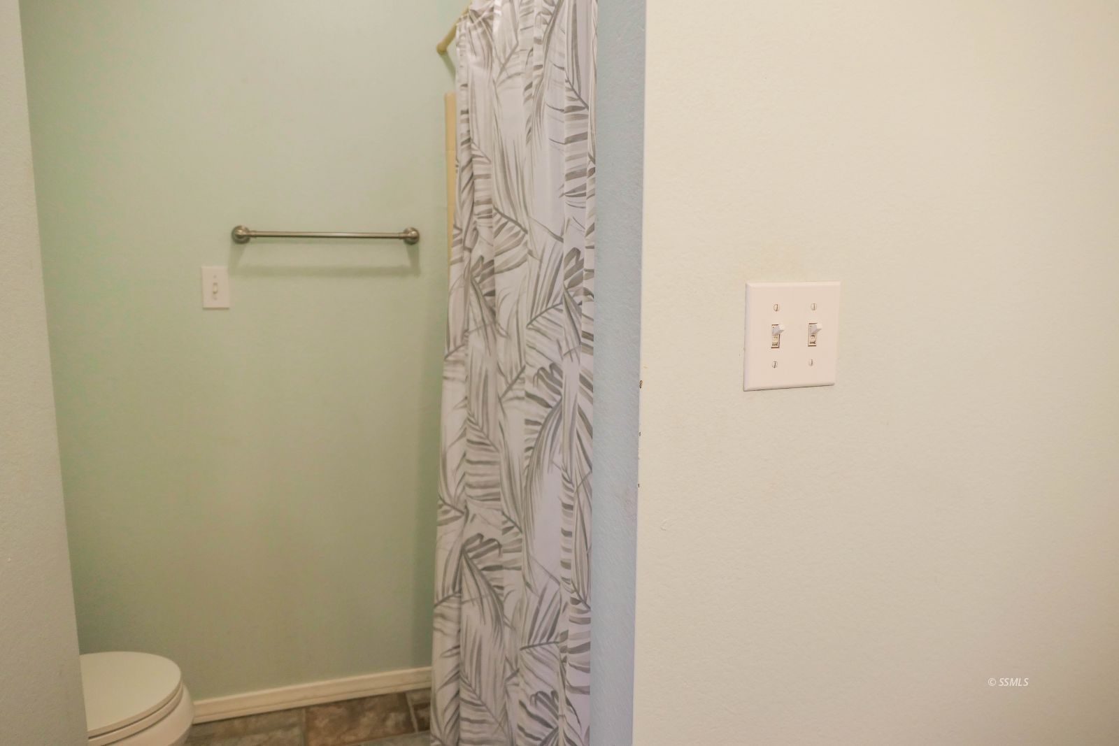 601 Heather Court Ridgecrest, CA 93555 - Photo 34 of 45 a bathroom with a shower curtain and a toilet