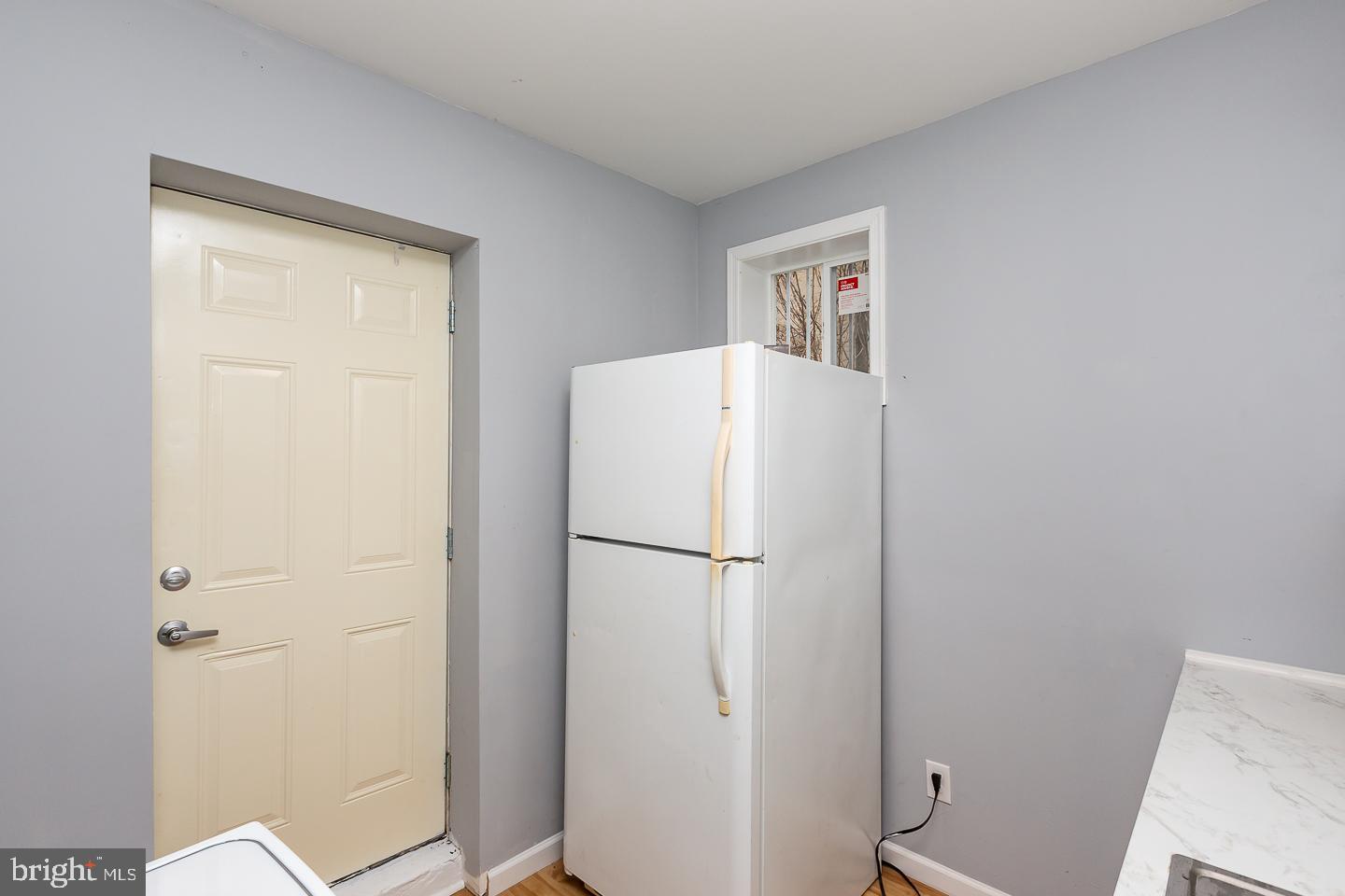 2735 Waterloo Street Philadelphia, PA 19133 - Photo 11 of 25 a white refrigerator freezer and a table