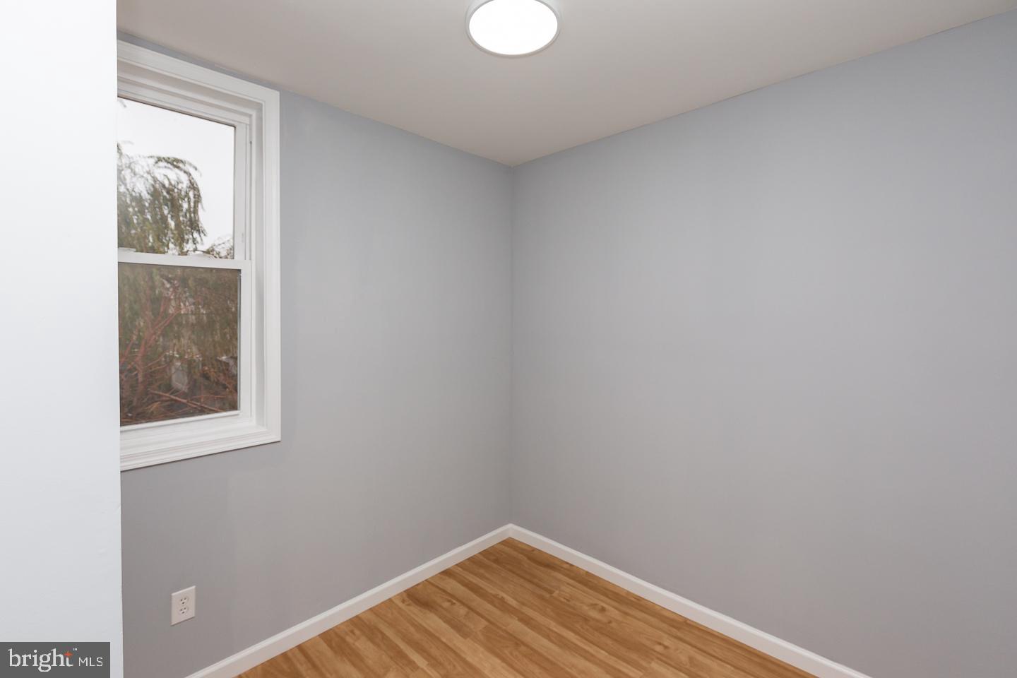 2735 Waterloo Street Philadelphia, PA 19133 - Photo 16 of 25 a view of an empty room with wooden floor and a window