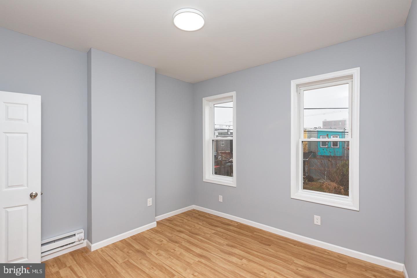 2735 Waterloo Street Philadelphia, PA 19133 - Photo 17 of 25 a view of an empty room with wooden floor and a window