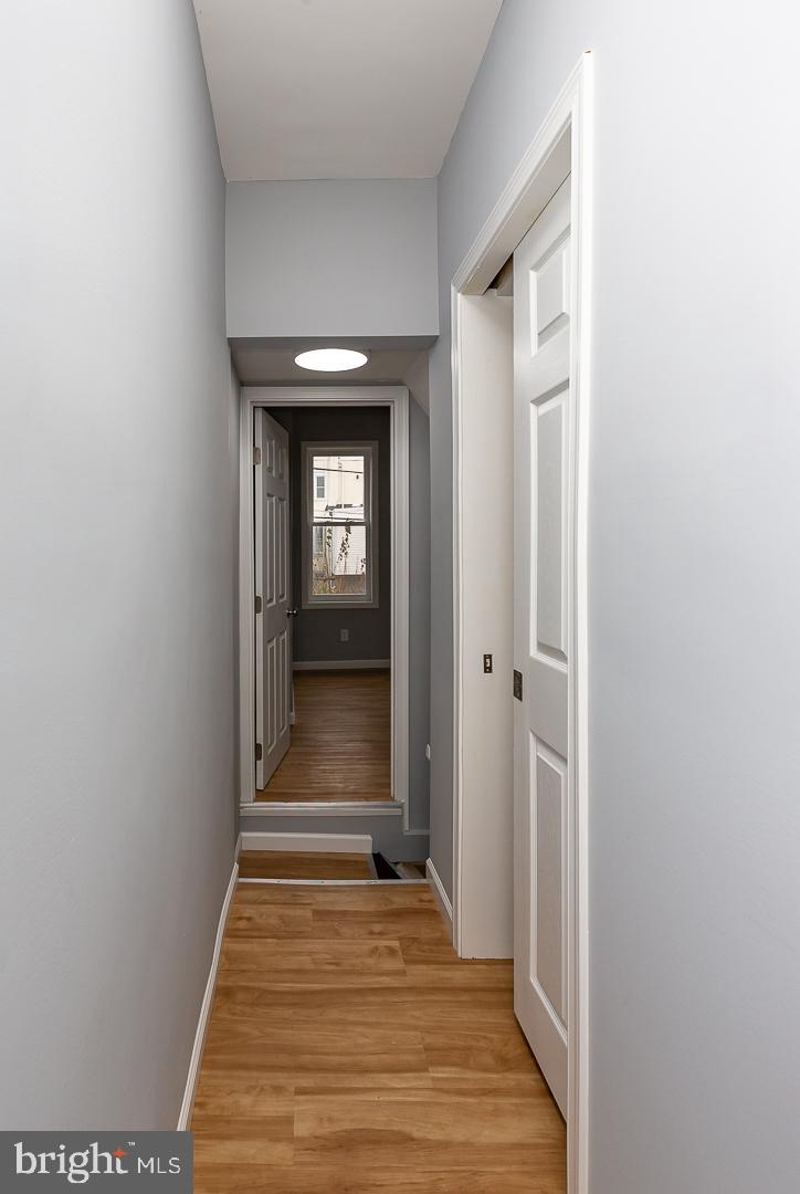 2735 Waterloo Street Philadelphia, PA 19133 - Photo 20 of 25 a view of a hallway with wooden floor and a bathroom