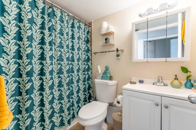 a white toilet sitting next to a bathroom sink