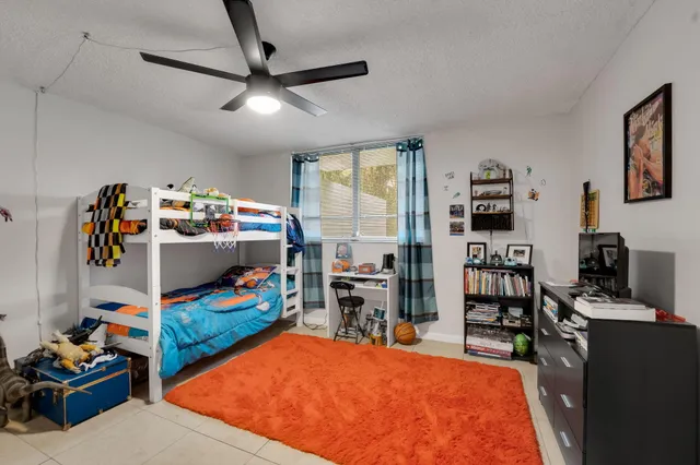 a bedroom with furniture and a flat screen tv