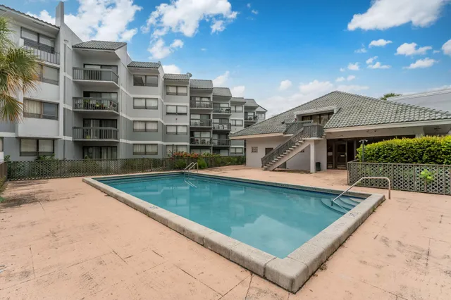 a view of swimming pool with outdoor seating and plants
