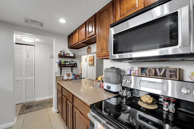 a kitchen with stainless steel appliances a stove a microwave and cabinets