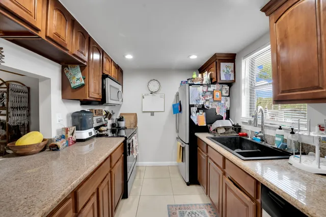 a kitchen with stainless steel appliances granite countertop a sink stove and cabinets