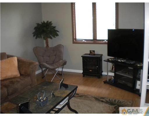 123 Redpine Loop Old Bridge, NJ 08857 - Photo 14 of 24 a living room with furniture and a flat screen tv