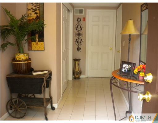 123 Redpine Loop Old Bridge, NJ 08857 - Photo 18 of 24 a hallway with a table and a chairs