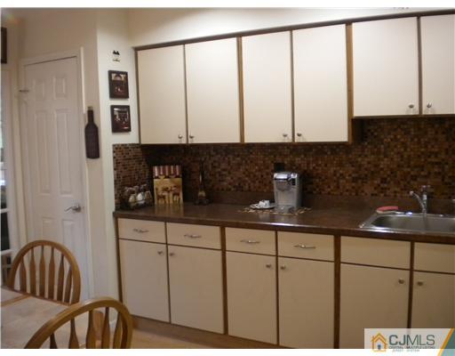123 Redpine Loop Old Bridge, NJ 08857 - Photo 3 of 24 a kitchen with stainless steel appliances white cabinets and a granite counter tops