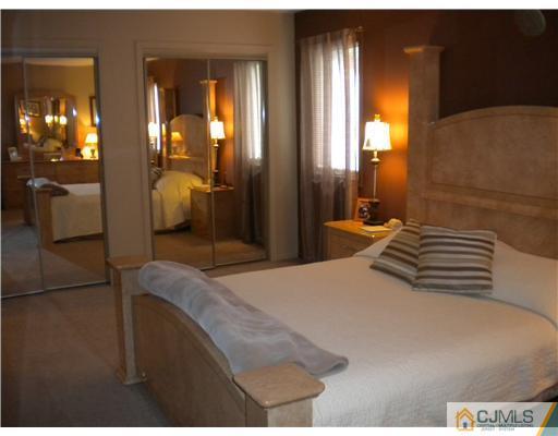 123 Redpine Loop Old Bridge, NJ 08857 - Photo 10 of 24 a bedroom with a bed and lamp