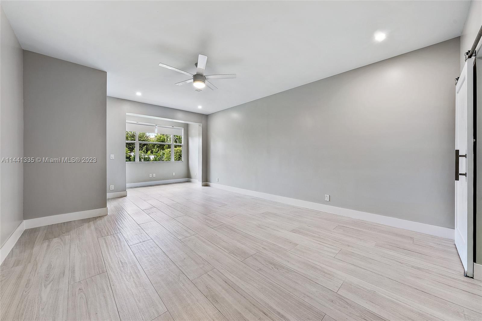 3670 Northwind Court Jupiter, FL 33477 - Photo 13 of 45 wooden floor in an empty room with a window
