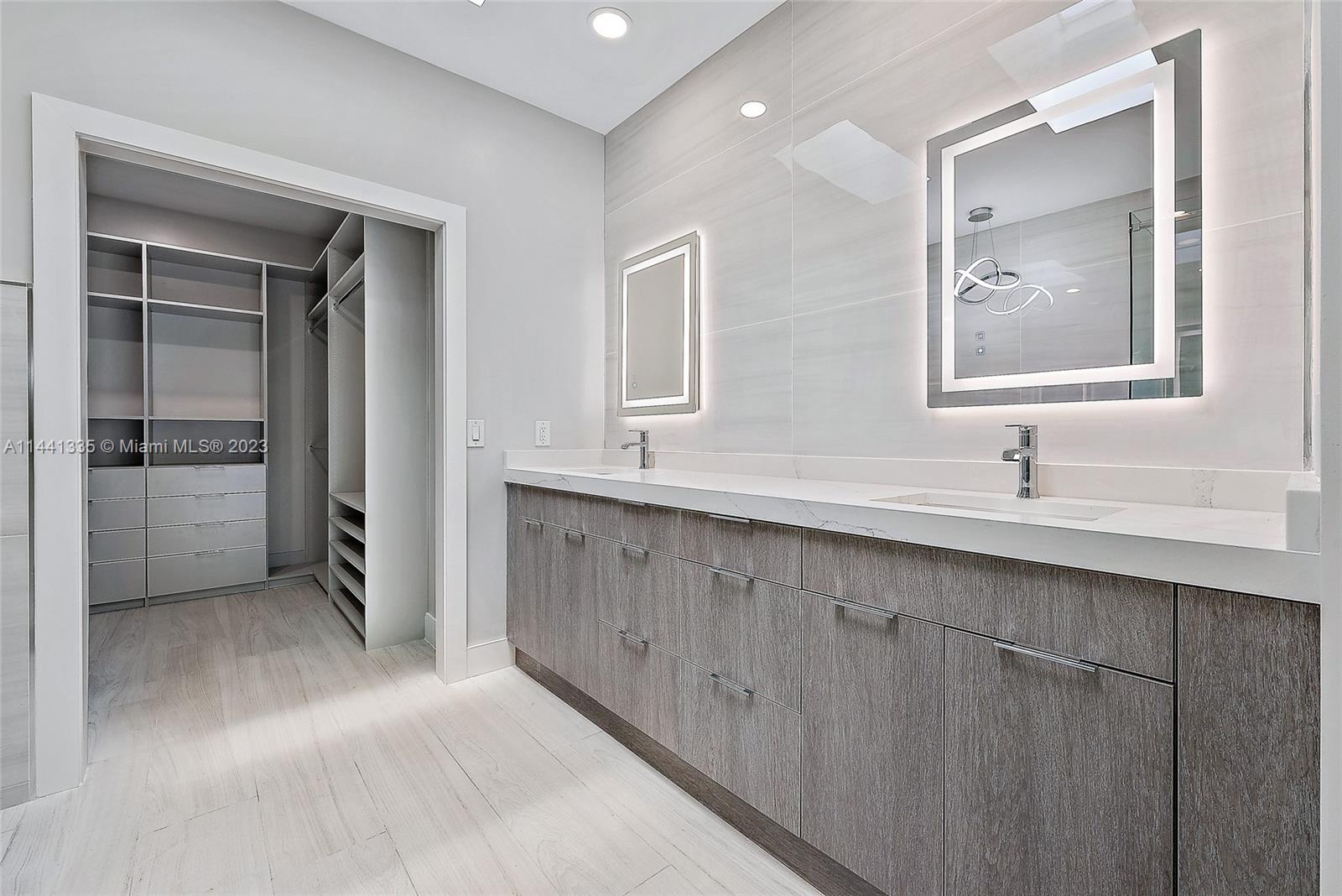 3670 Northwind Court Jupiter, FL 33477 - Photo 15 of 45 a bathroom with a sink mirror and vanity