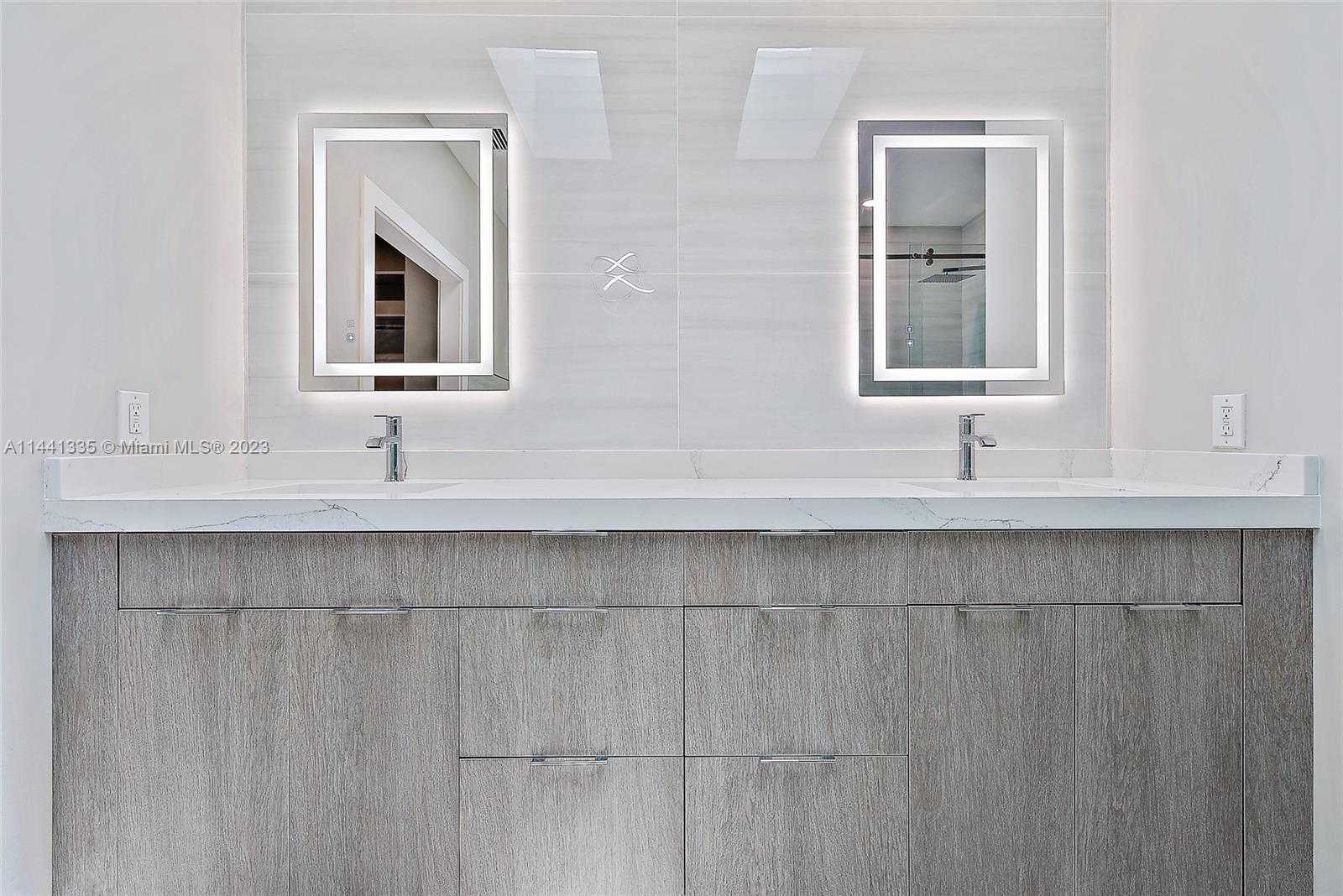 3670 Northwind Court Jupiter, FL 33477 - Photo 16 of 45 a bathroom with a sink and a mirror