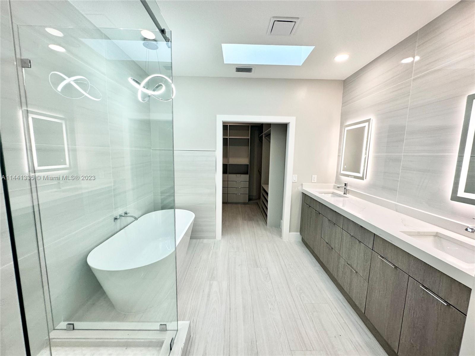 3670 Northwind Court Jupiter, FL 33477 - Photo 18 of 45 a bathroom with a double vanity sink and a mirror