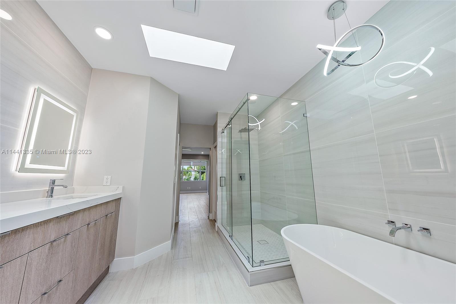 3670 Northwind Court Jupiter, FL 33477 - Photo 20 of 45 a bathroom with a double vanity sink toilet and shower
