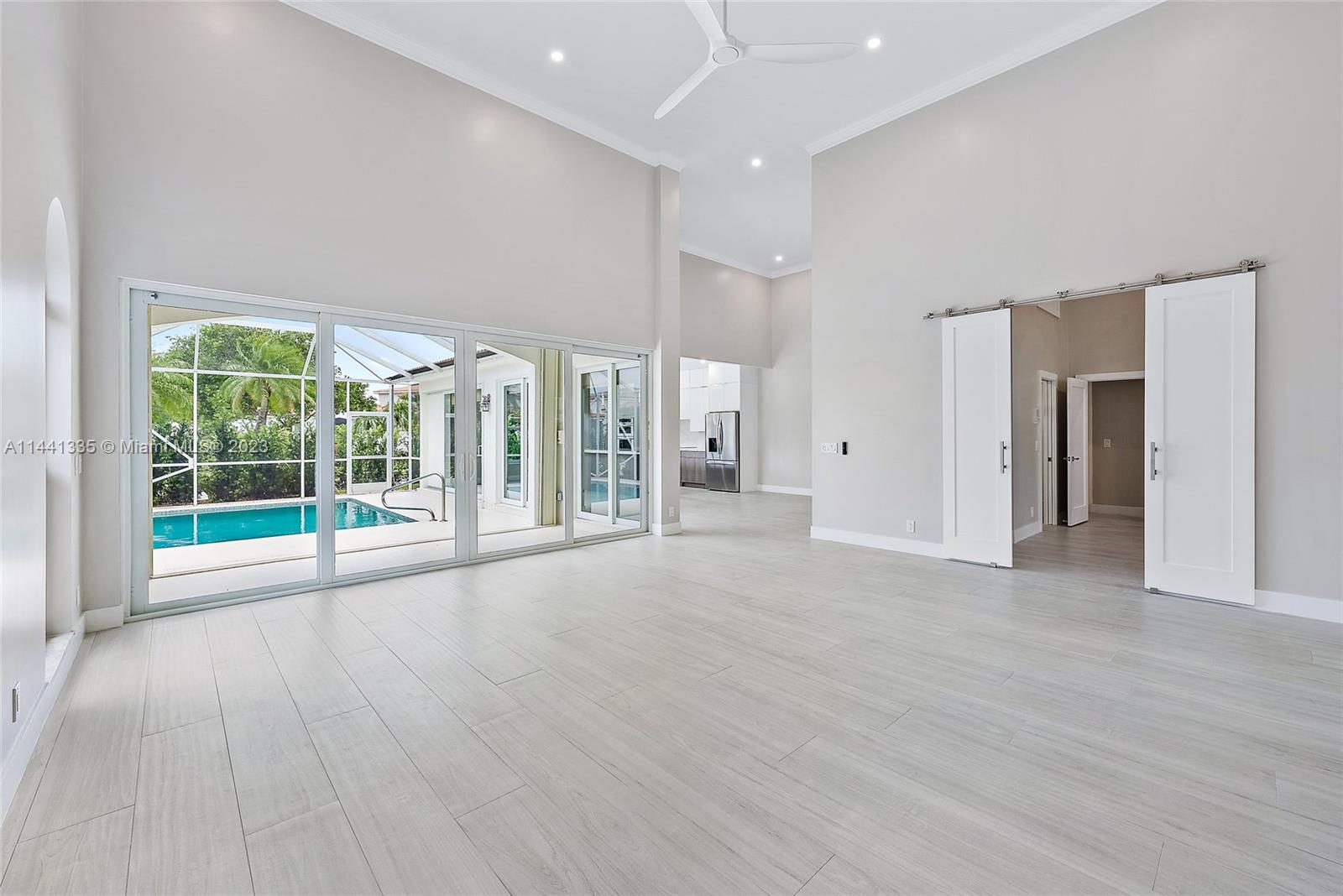 3670 Northwind Court Jupiter, FL 33477 - Photo 2 of 45 a view of an empty room with wooden floor and a window