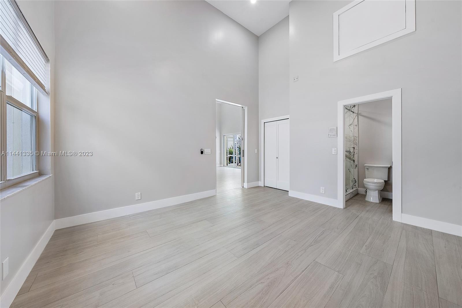 3670 Northwind Court Jupiter, FL 33477 - Photo 21 of 45 a view of a room with wooden floor and a window