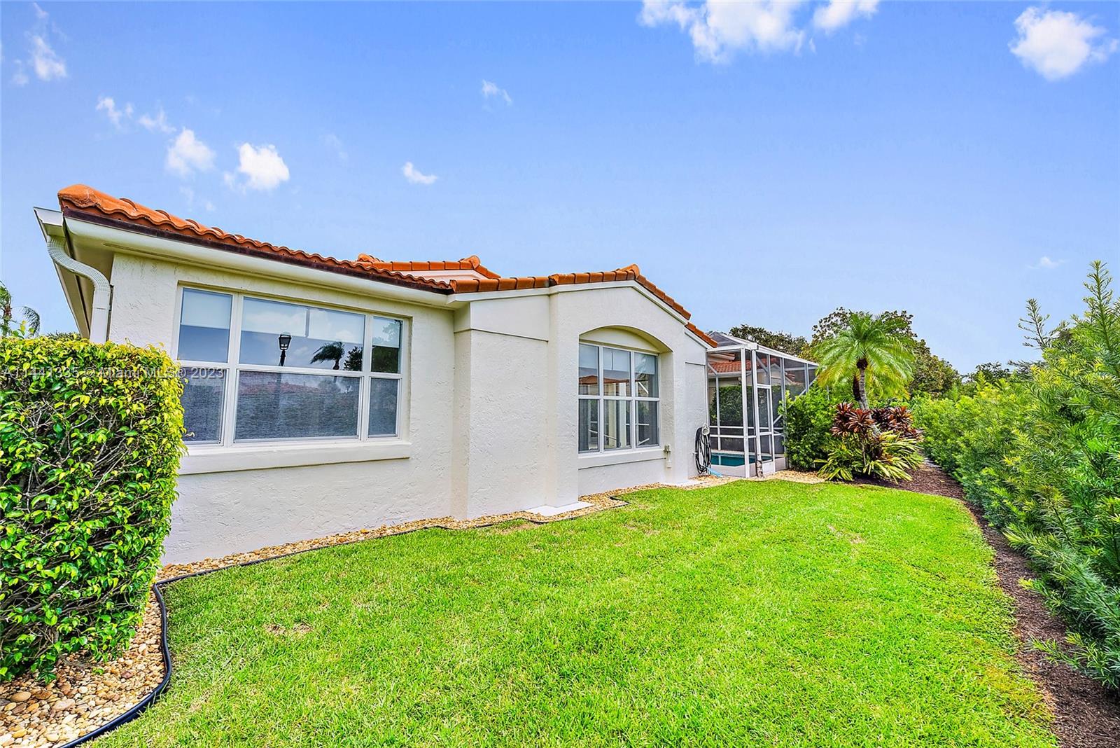 3670 Northwind Court Jupiter, FL 33477 - Photo 33 of 45 a front view of a house with a yard and potted plants