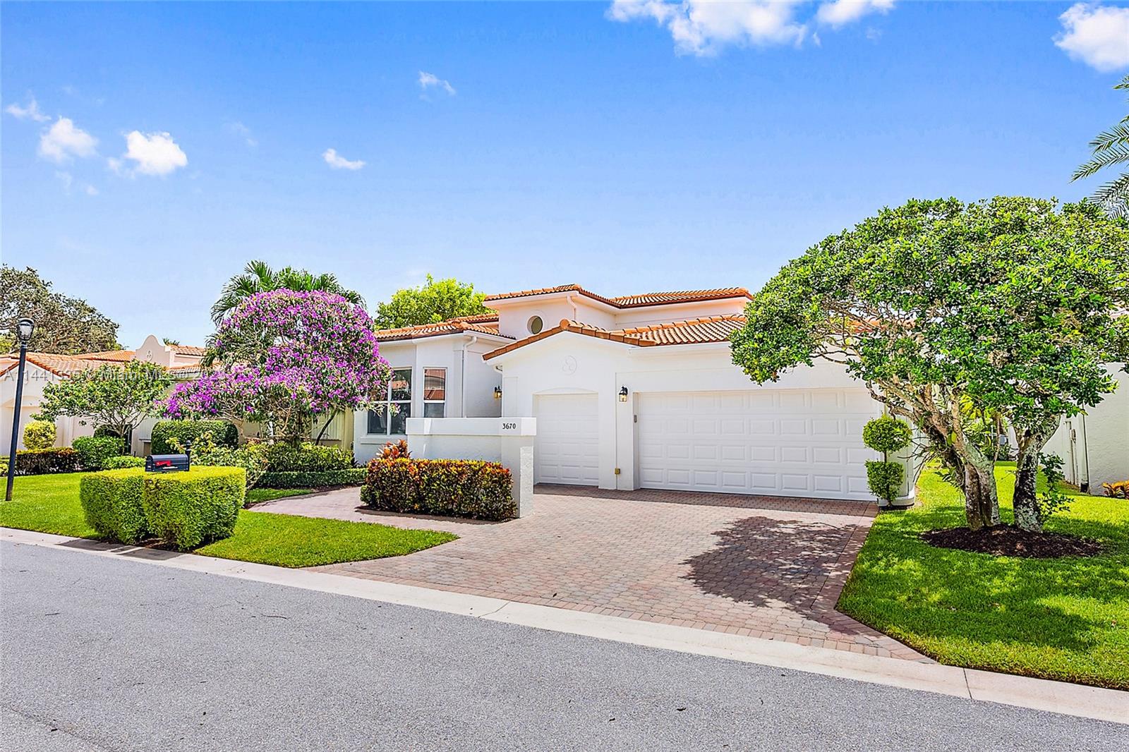 3670 Northwind Court Jupiter, FL 33477 - Photo 37 of 45 a front view of a house with a yard and garage