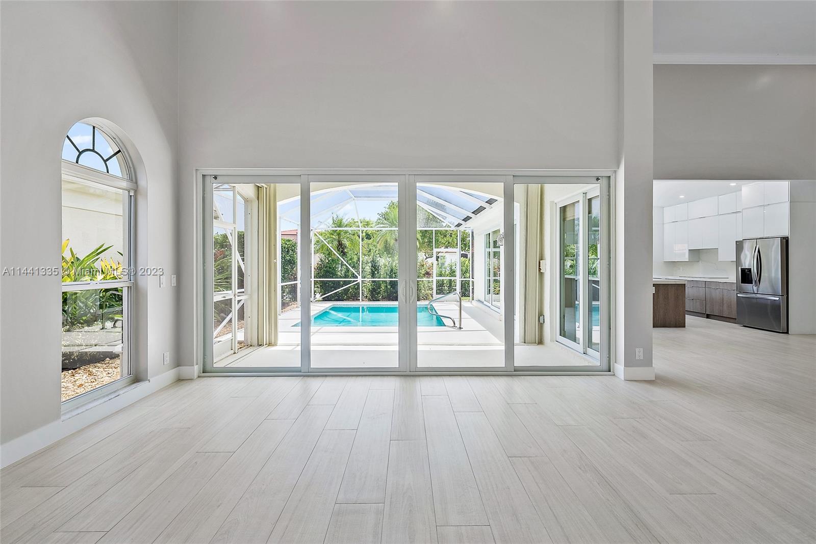 3670 Northwind Court Jupiter, FL 33477 - Photo 4 of 45 a view of a room with wooden floor and windows