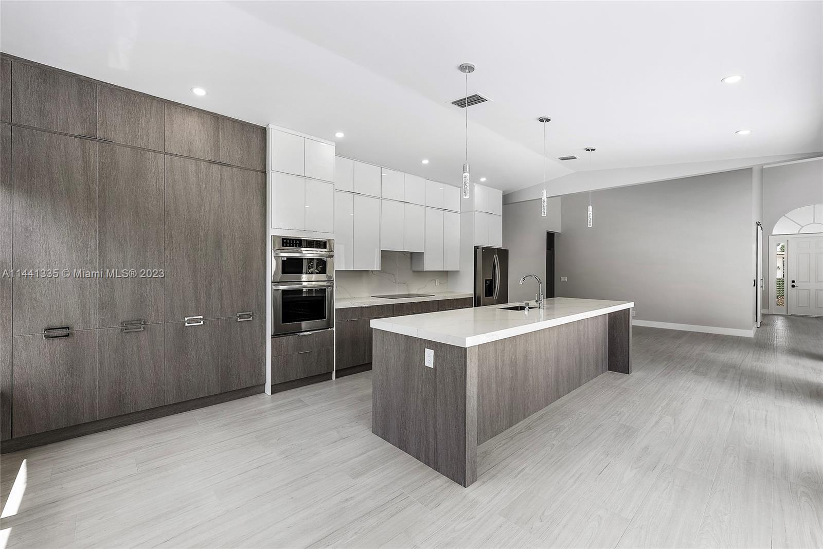 3670 Northwind Court Jupiter, FL 33477 - Photo 44 of 45 a large kitchen with a large counter top stainless steel appliances and cabinets