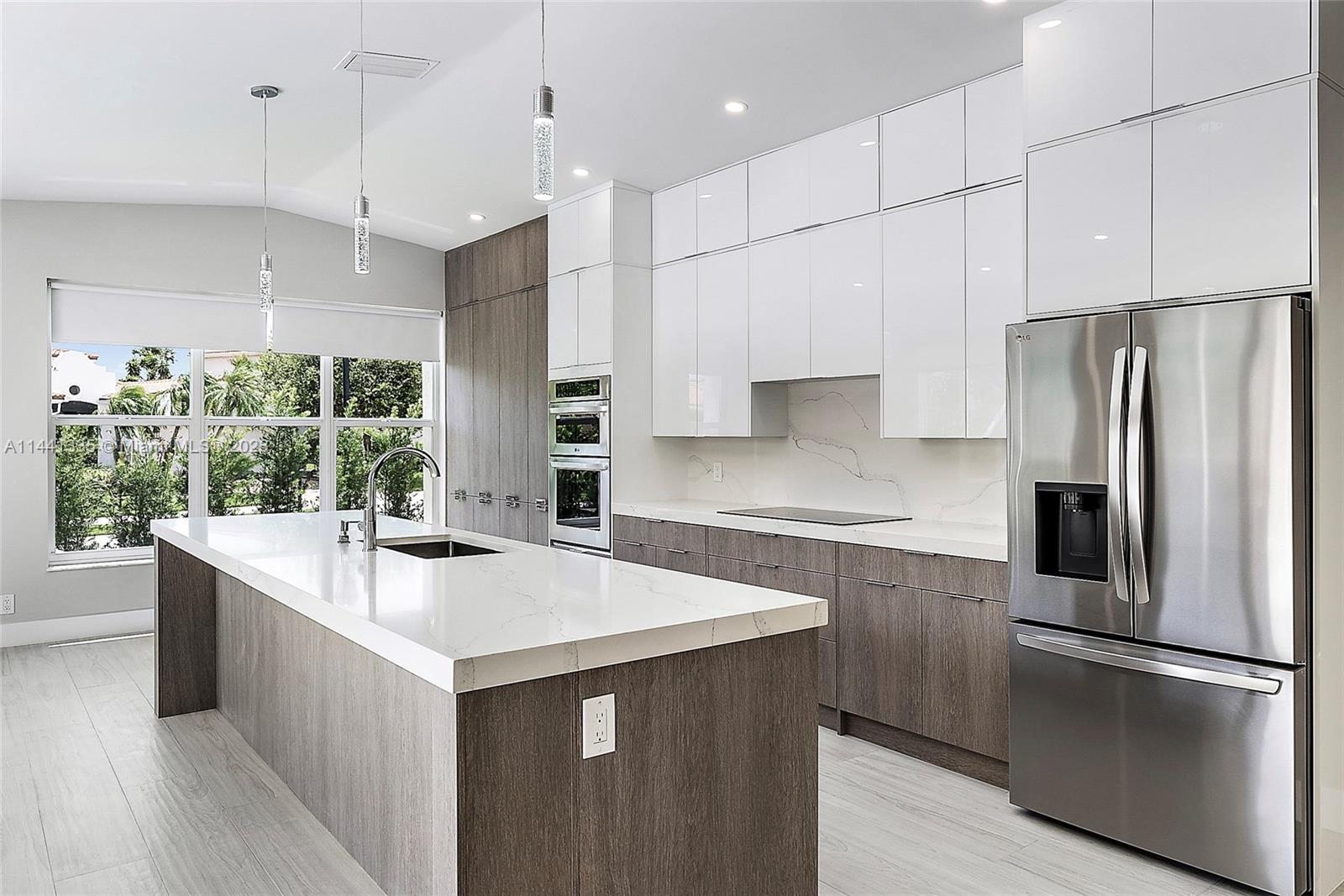 3670 Northwind Court Jupiter, FL 33477 - Photo 6 of 45 a kitchen with stainless steel appliances granite countertop a refrigerator a sink and a stove
