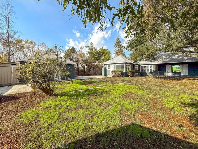 a view of a house with yard and sitting area