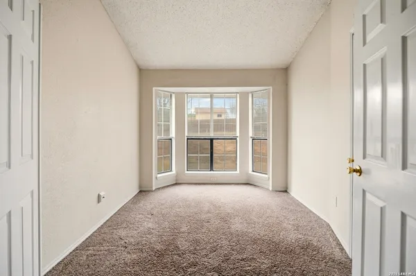 a view of a room with a large window and front door