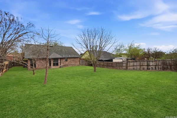 a view of a house with a backyard