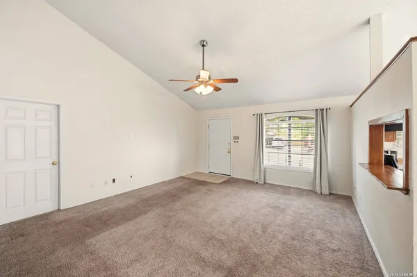 an empty room with windows and closet