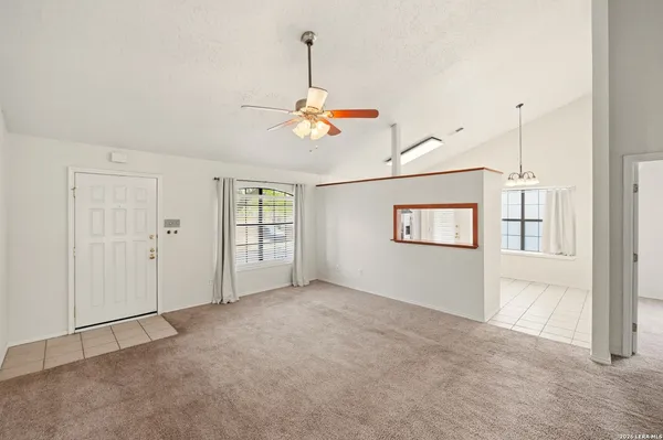 a view of a room with window and ceiling fan