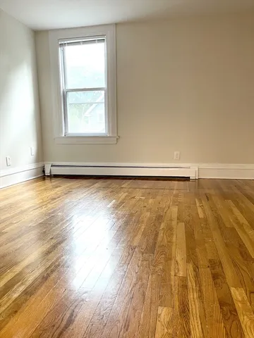 a view of an empty room and wooden floor