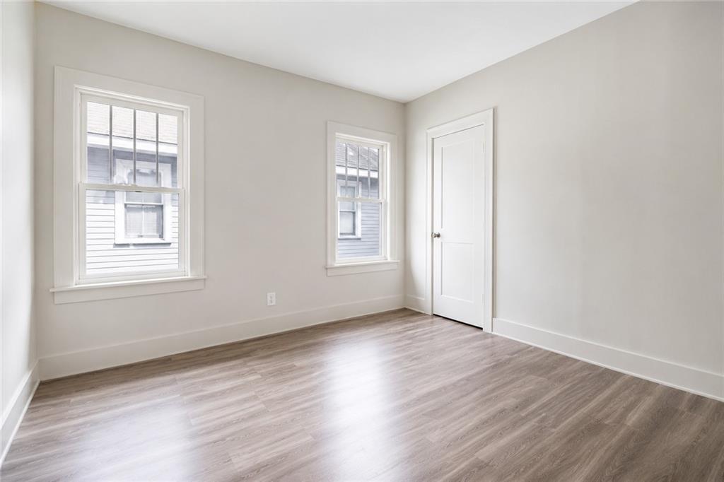 665 Lexington Avenue Southwest Atlanta, GA 30310 - Photo 15 of 33 an empty room with wooden floor and windows