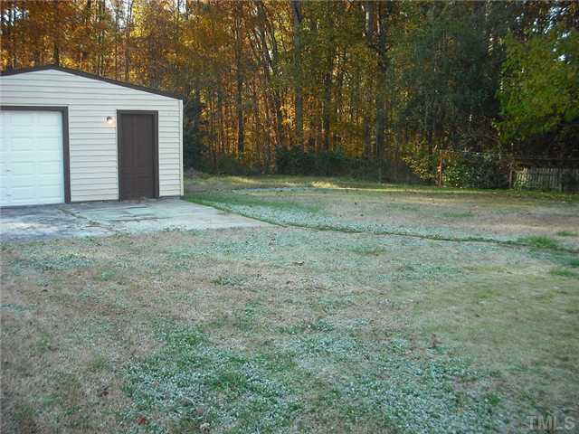 325 Grovemont Road Raleigh, NC 27603 - Photo 16 of 18 a view of a backyard with large trees