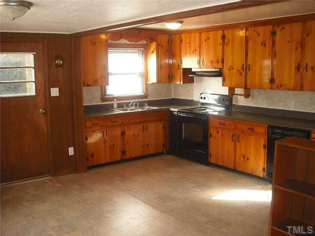325 Grovemont Road Raleigh, NC 27603 - Photo 3 of 18 a kitchen with stainless steel appliances granite countertop a sink a stove and a refrigerator