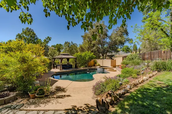 a view of a house with a yard and sitting area