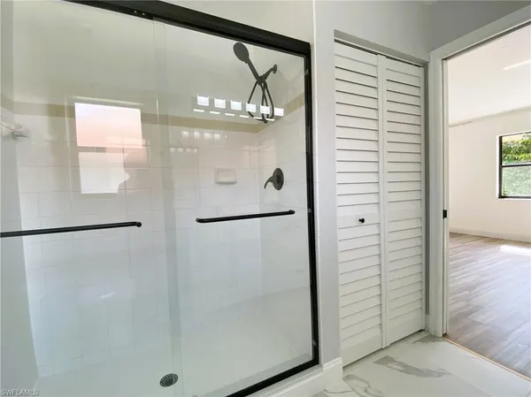 a bathroom with a glass shower door