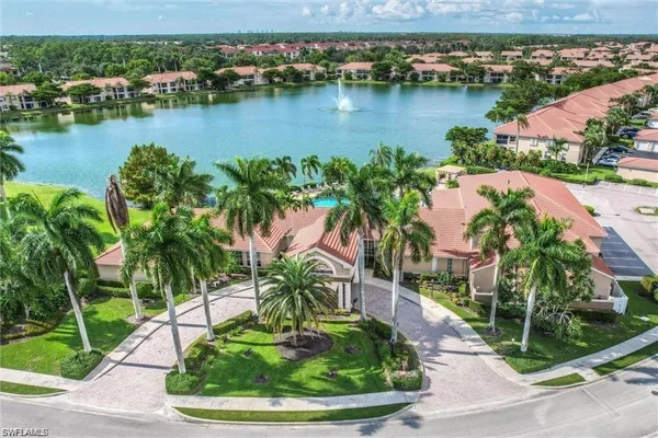 an aerial view of residential houses with outdoor space and lake view