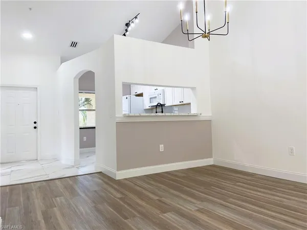 a view of a kitchen with wooden floor and windows