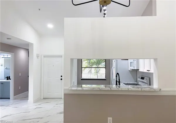a kitchen with stainless steel appliances a sink and a window