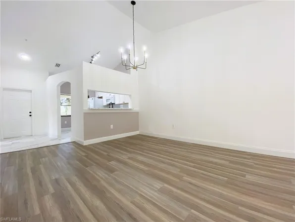 a view of a kitchen with a sink and refrigerator